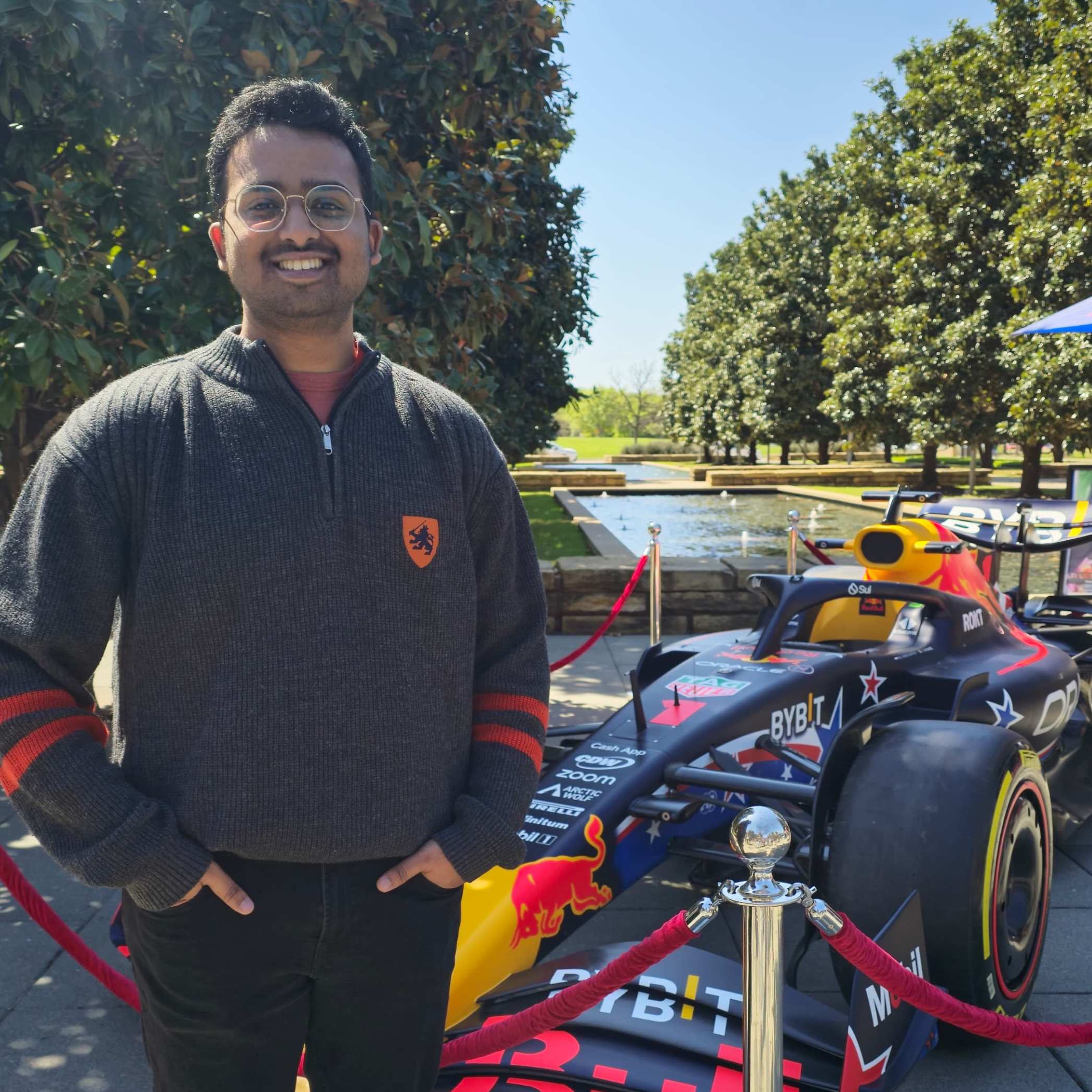 Amoghavarsha Rao standing beside a Red Bull Formula 1 car