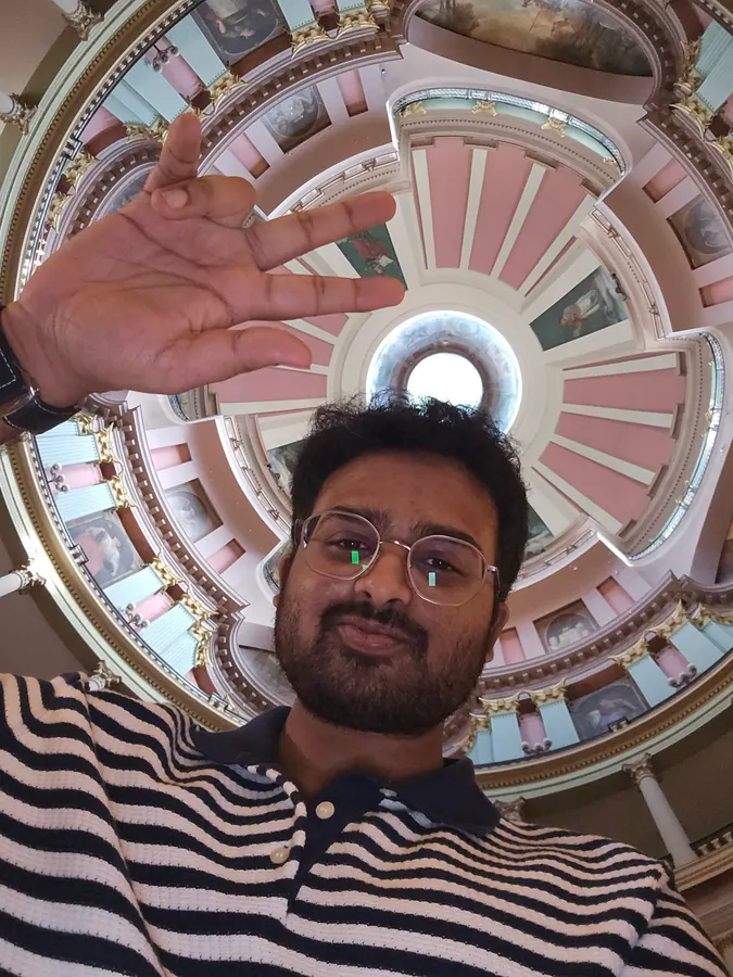 Amogh taking a selfie beneath the painted dome of the Old Courthouse