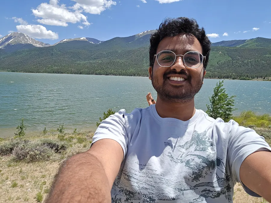Amogh taking a selfie by Twin Lakes with mountains behind him